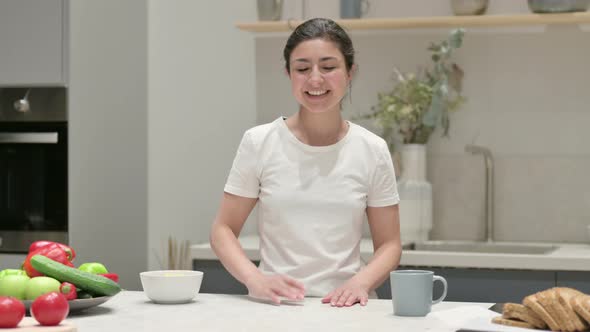 Young Indian Woman Doing Video Call While Standing in Kitchen