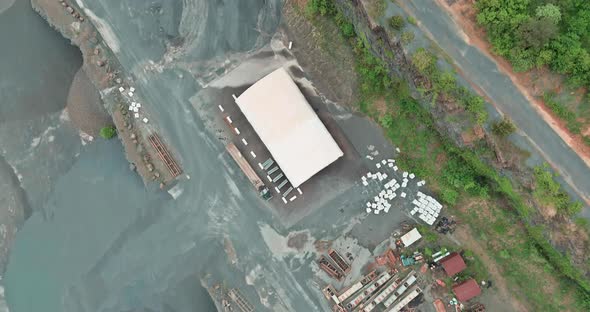 Aerial panorama view dumpers and machines are working in the quarry mine for special equipment