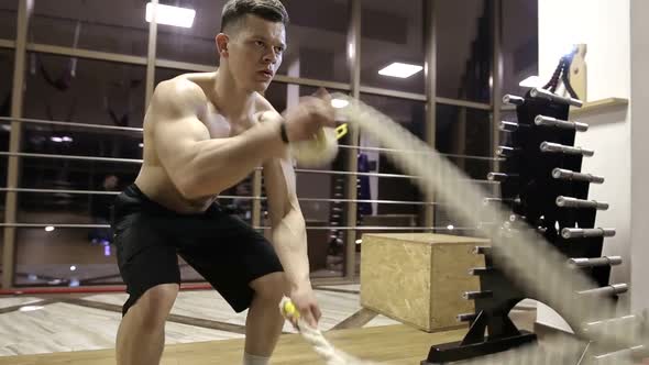 Session battle ropes. an athlete who develops a gym in a functional training