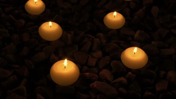 Candles Glowing On The Rocks Outside