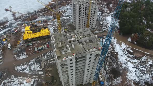 Aerial of Building Skyscraper with Workers on Top