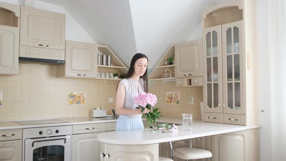 The Wife Creates Comfort in the Home Kitchen She Puts a Beautiful Bouquet of Peonies