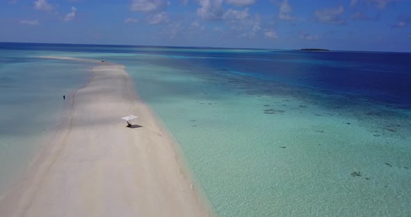 Natural aerial island view of a white sandy paradise beach and blue ocean background in high resolut