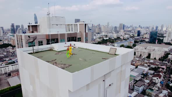 Drone Shot Of Fashion Models Dancing On City Rooftop