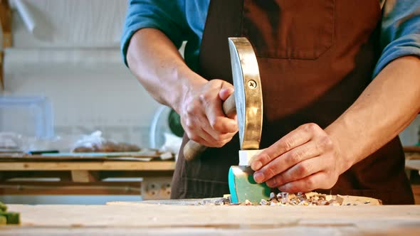 Young man with a hammer at work in studio