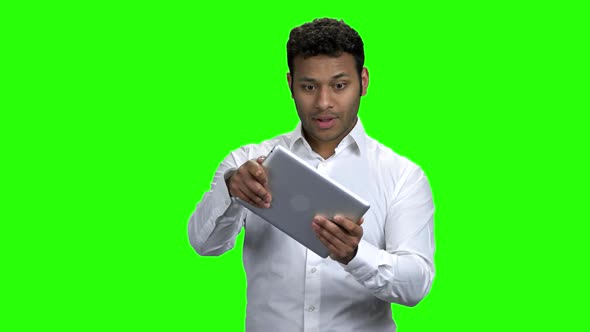 Enthusiastic Indian Man Playing Game on Tablet Pc