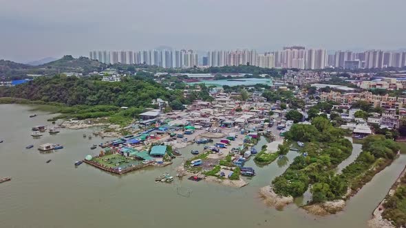 A dynamic ascending aerial footage of the fishing village in Lau Fau Shan in the New Territories of