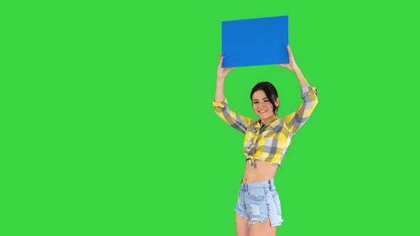 Girl with an Empty Board Announcing New Round on a Green Screen, Chroma Key