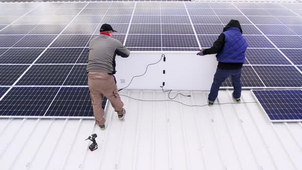 Solar Technician Installing Solar Panels on House Roof