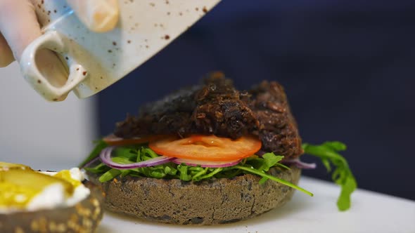 Cooking fast food in restaurant. Close up of chef cooking burgers in kitchen