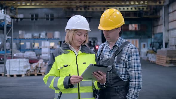 Follow Footage of Employees Male and Famale Warehouse Worker Engineer in Hard Hat Working