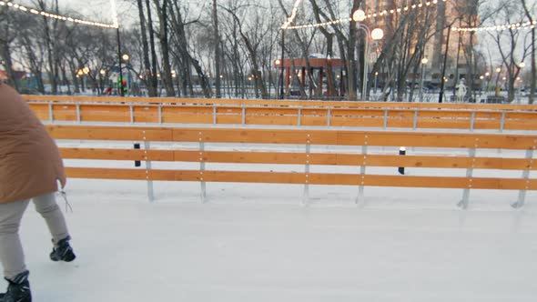 Family Having Fun On Ice Rink