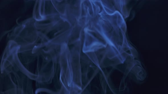 Abstract Smoke Cloud. Blue Smoke Slowly Floating Through Space Against Black Background. Close Up