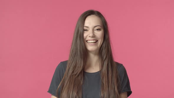Happy Attractive Brunette Woman Smiling at Camera and Starts to Laugh Out Lould From Funny Joke