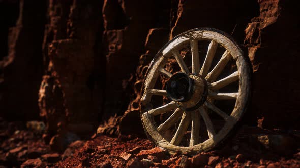 Old Wooden Cart Wheel on Stone Rocks