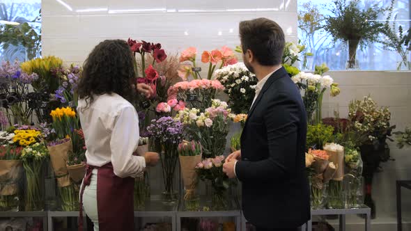 Florist Selecting Flowers for Bouquet with Client