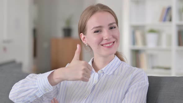 Portrait of Positive Young Woman Doing Thumbs Up 