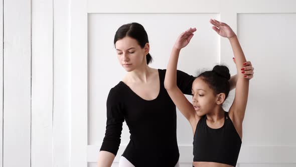 Woman Teaching African Girl How to Dance Ballet