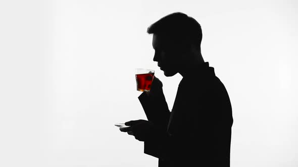 Dark Silhouette of Man Drinking Glass of Tea, Recreation, pH Balance Restore