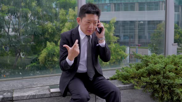 Japanese businessman talking on a cell phone