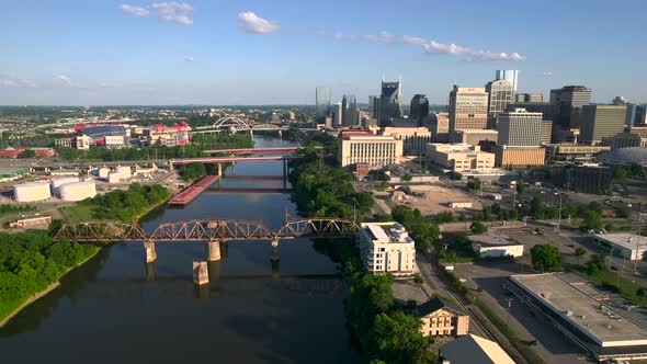 Aerial view of bridges on a river, in sunny Nashville, USA - tracking, drone shot