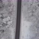 Top down aerial shot of road in snow covered forest trees. - VideoHive Item for Sale