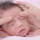 Close Up Shot Hands Of Mother Massaging Sleeping Baby Carefully. - VideoHive Item for Sale