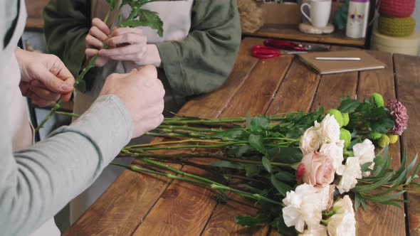 Florists Creating Bouquet Of Flowers