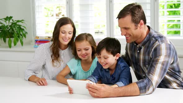 Happy family using digital tablet