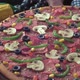 A cooked pizza with various toppings and sesame on a decorated table - VideoHive Item for Sale