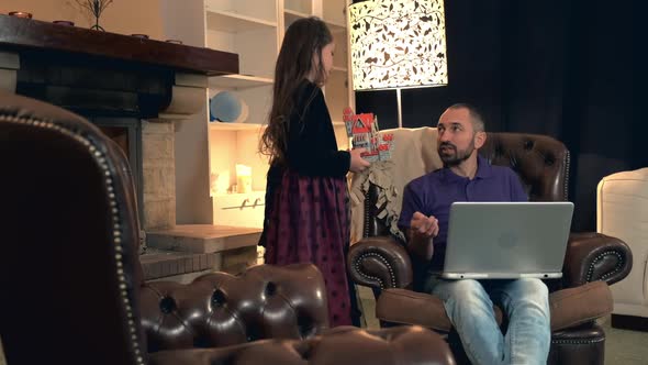 Dad Is Too Busy To Play with His Pretty Daughter Working on Computer