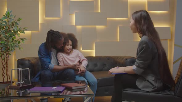 Caring African Dad and School Age Daughter Consulting with Child Psychologist