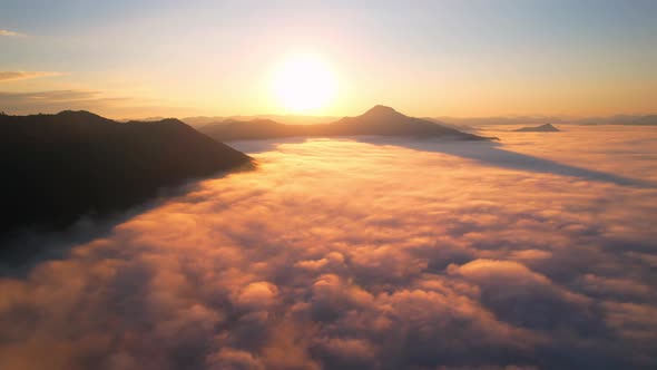 4K Aerial view flying in fog. clouds at sunset fog.