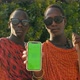 Extremely Happy Masai Tribe Men Showing Green Screen on Smartphone and Making Thumb Up Sign - VideoHive Item for Sale