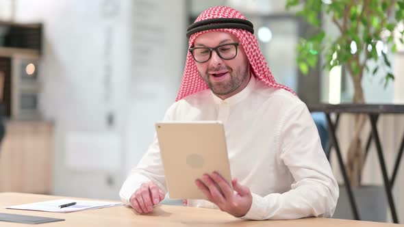 Professional Young Arab Businessman Doing Video Call on Tablet in Office