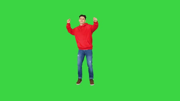 Hip-Hop Style Man in Red Hoody Dancing on a Green Screen, Chroma Key.