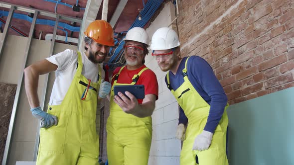 Construction Workers Using Smartphone During Break at Work