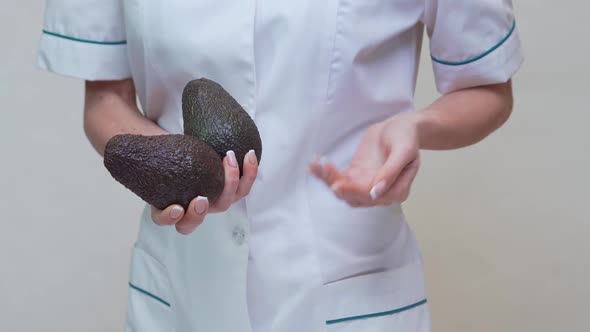 Nutritionist Doctor Healthy Lifestyle Concept - Holding Organic Avocado