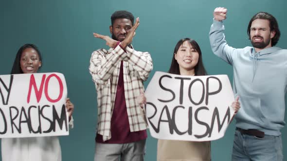 Group of Young Activists Protest Against Discrimination with Stop Racism Poster