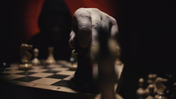 Unrecognizable Man in Hoodie Moving White Queen Defeating White King of Opponent During Chess Game