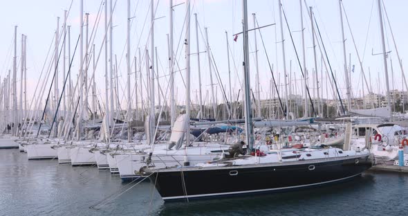 Yachts with masts and at anchors in marina