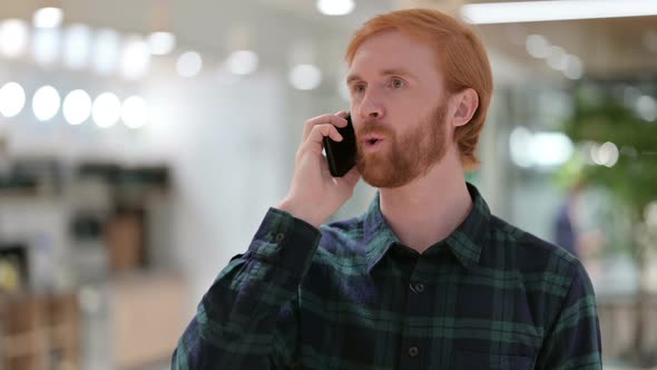 Portrait of Beard Redhead Man Talking on Smartphone