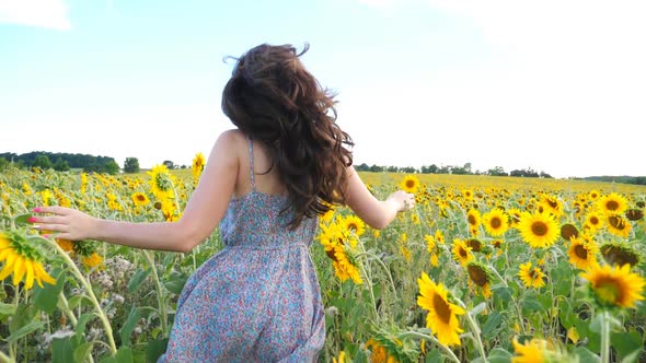 Close Up of Pretty Girl Running Through Sunflower Field