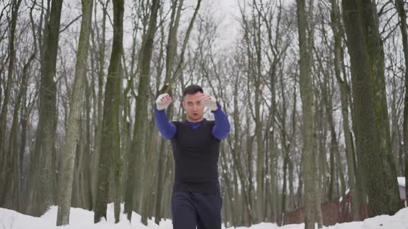 A Guy in a Sports Uniform is Doing Exercises