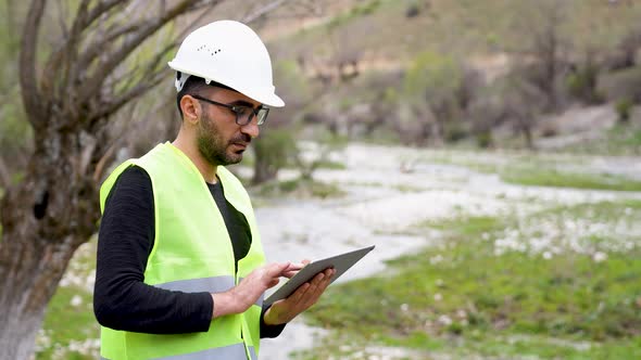 Engineer Investigates in Electric Water Dam