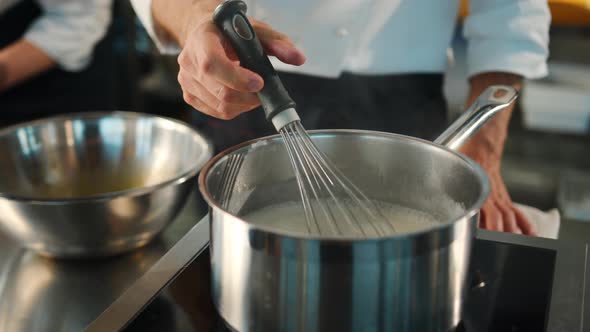 Close-up: stirring milk in a bowl on the stove