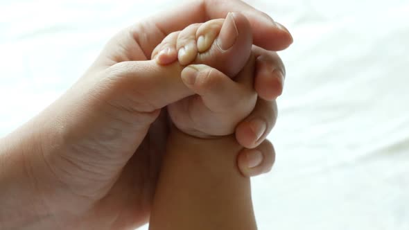 Newborn Baby Touching Mother Hand