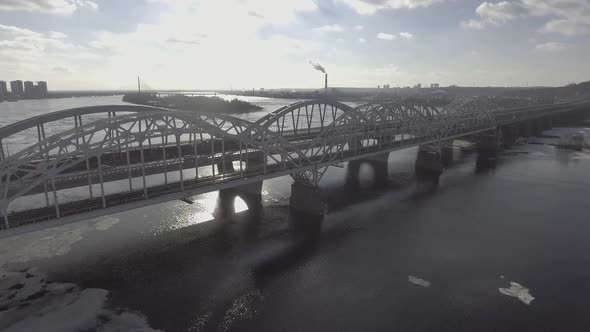 Flying Over the Railway Bridge in the Early Morning, the Sun's Rays Shine Through the Bridge