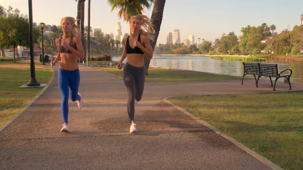 Athletic Twins Running In The Park Slow-Motion