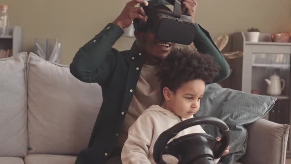 Father and Little Son Experiencing Virtual Reality at Home